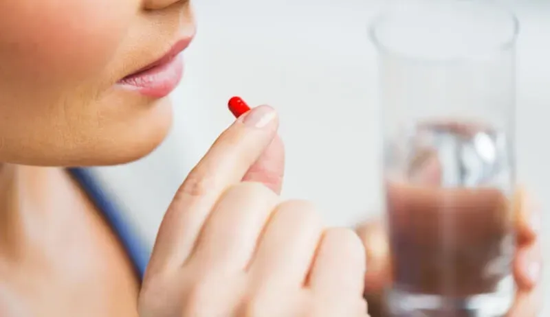 woman taking a pill