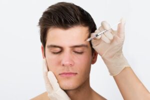 43306418 - close-up of person hands injecting syringe with botox for face treatment