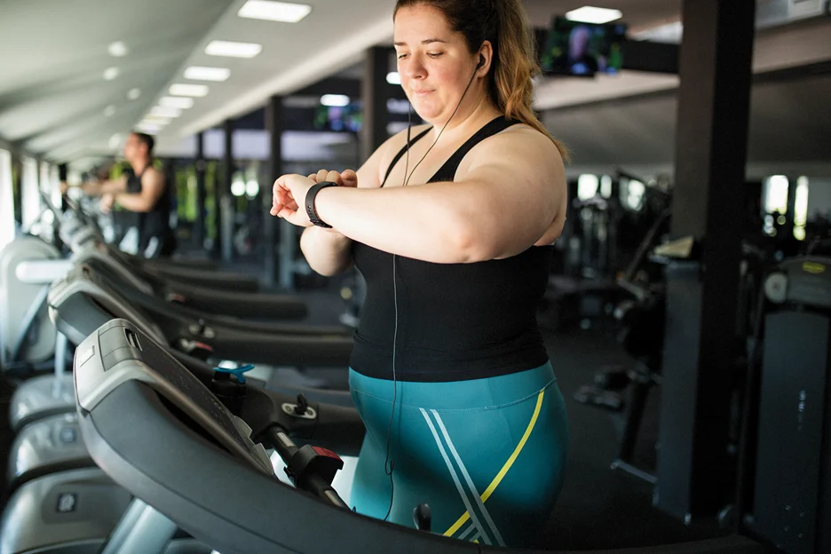 an obese woman exercising in the gym