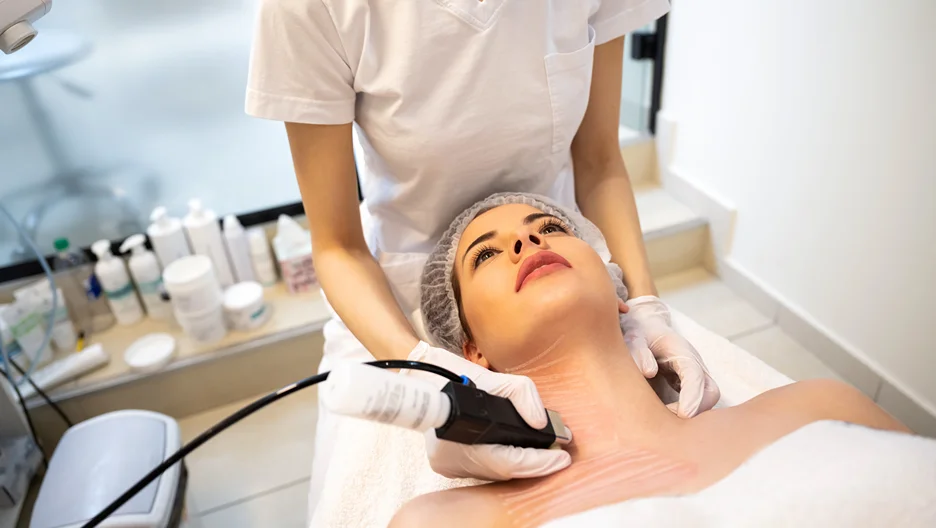 a woman getting laser hair removal treatment on neck